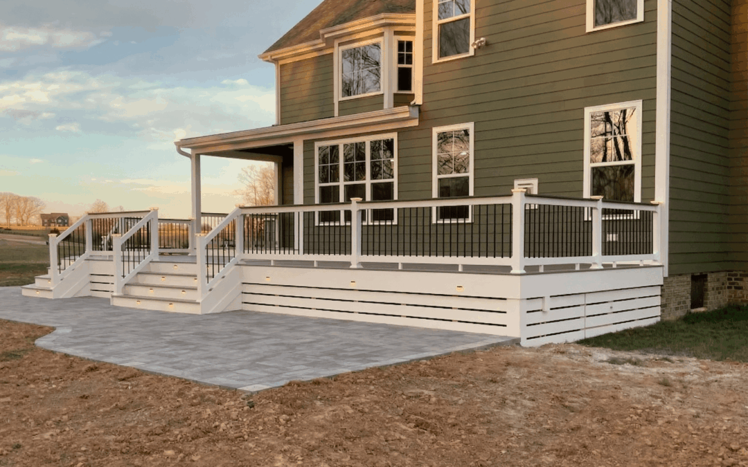 A beautifully remodeled white deck project attached to a two-story house, created by a professional deck company.